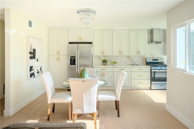 8213 Ethel Ave, North Hollywood, CA 91605 - dining room with baseboards, light wood-style floors, and healthy amount of natural light