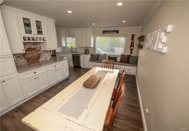 7680 Jadeite Ave, Rancho Cucamonga, CA 91730 - kitchen with dishwasher, crown molding, white cabinets, backsplash, and dark wood-style floors