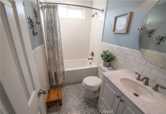 7680 Jadeite Ave, Rancho Cucamonga, CA 91730 - full bathroom with tile walls, toilet, shower / bath combo with shower curtain, vanity, and a wainscoted wall