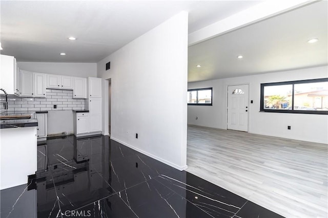 2025 Rio Vis, Needles, CA 92363 - kitchen featuring lofted ceiling, white cabinets, recessed lighting, decorative backsplash, and open floor plan