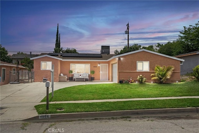 4966 N Stoddard Ave, San Bernardino, CA 92407 - ranch-style house featuring solar panels, a gate, stucco siding, and outdoor lounge area