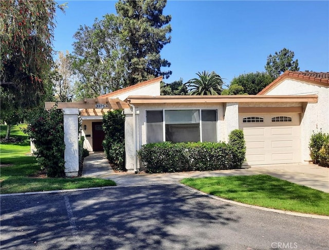3375 Punta Alta Unit A, Laguna Woods, CA 92637 - view of front of home with an attached garage, driveway, and stucco siding