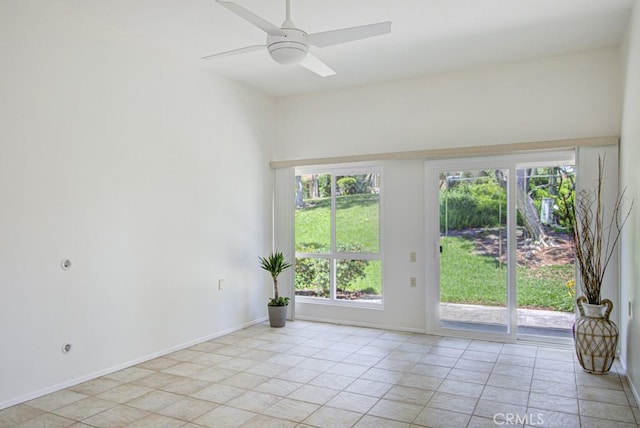 3375 Punta Alta Unit A, Laguna Woods, CA 92637 - spare room with healthy amount of natural light, baseboards, a ceiling fan, and light tile patterned floors