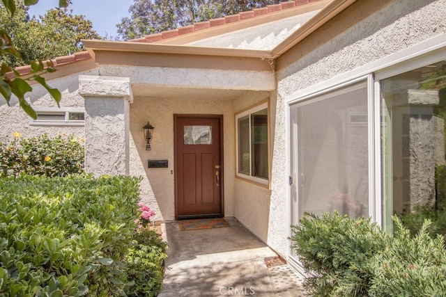 3375 Punta Alta Unit A, Laguna Woods, CA 92637 - doorway to property featuring stucco siding