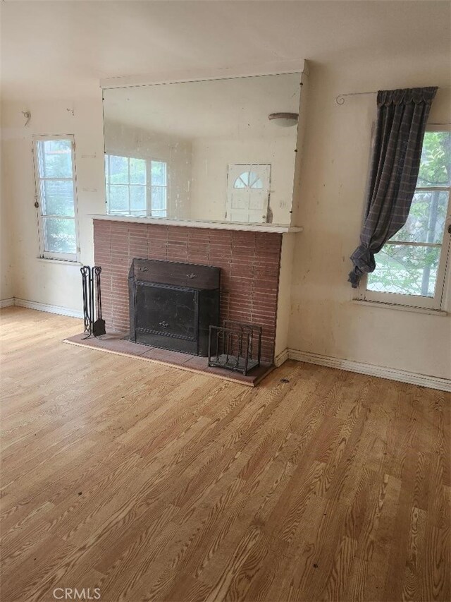 1280 E Woodbury Rd, Pasadena, CA 91104 - unfurnished living room featuring wood finished floors, a fireplace, and baseboards