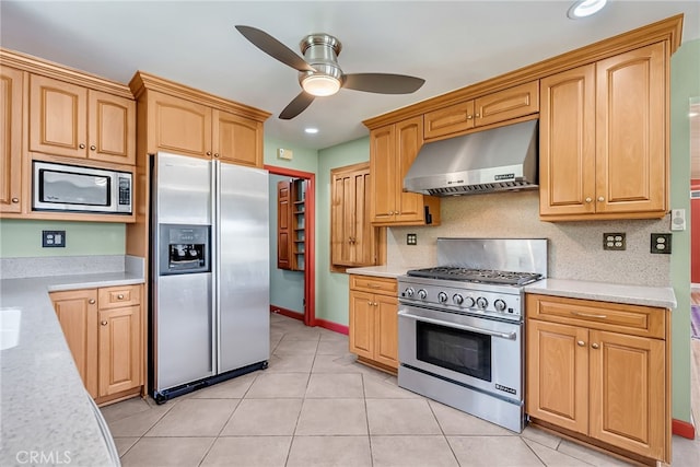 2886 Mcallister St, Riverside, CA 92503 - kitchen with appliances with stainless steel finishes, under cabinet range hood, ceiling fan, light tile patterned floors, and decorative backsplash