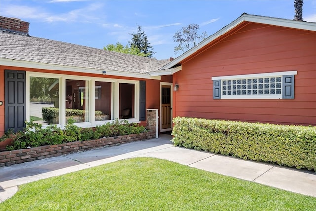 2886 Mcallister St, Riverside, CA 92503 - view of front of house featuring a chimney, a front yard, and a shingled roof
