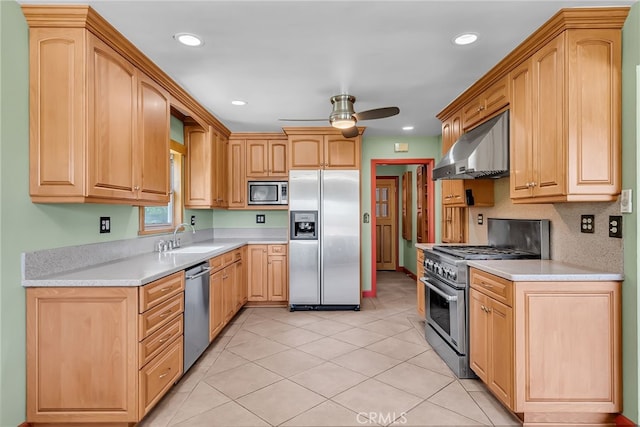 2886 Mcallister St, Riverside, CA 92503 - kitchen with stainless steel appliances, wall chimney range hood, a sink, a ceiling fan, and light countertops