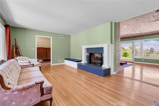 2886 Mcallister St, Riverside, CA 92503 - living area with wood finished floors, baseboards, a tiled fireplace, and wood ceiling