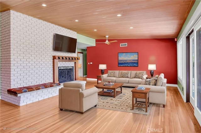 2886 Mcallister St, Riverside, CA 92503 - living room featuring wooden ceiling, an accent wall, light wood-type flooring, a fireplace, and a ceiling fan