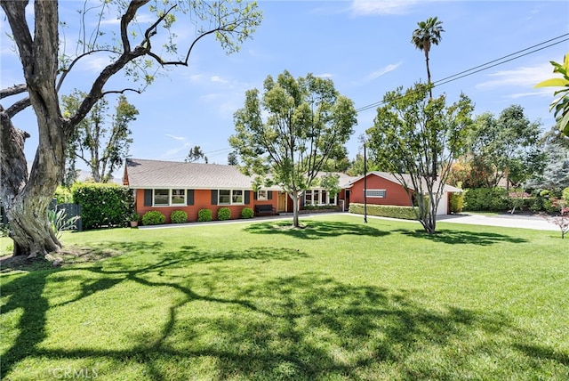 2886 Mcallister St, Riverside, CA 92503 - view of front facade with concrete driveway, a front yard, and a garage