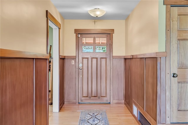 2886 Mcallister St, Riverside, CA 92503 - doorway featuring light wood-style flooring and wainscoting