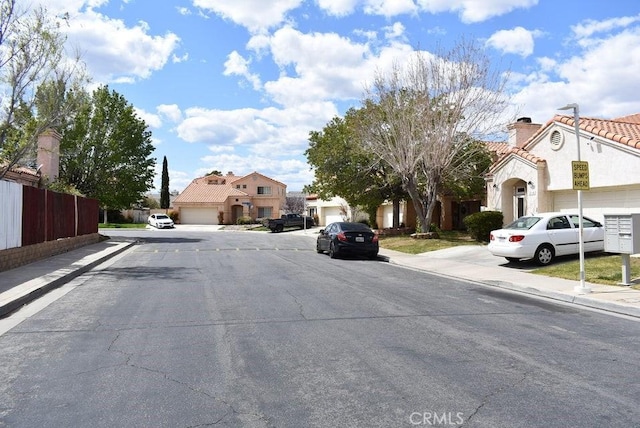 2125 Bramble Ln, Palmdale, CA 93550 - view of asphalt road featuring sidewalks, curbs, and a residential view