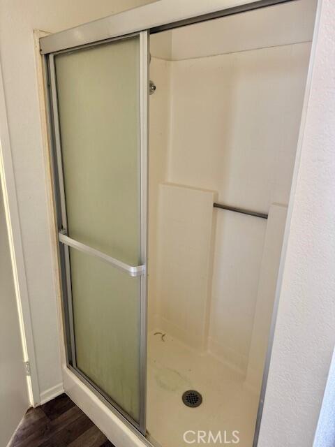 2125 Bramble Ln, Palmdale, CA 93550 - full bath with a shower stall and wood finished floors