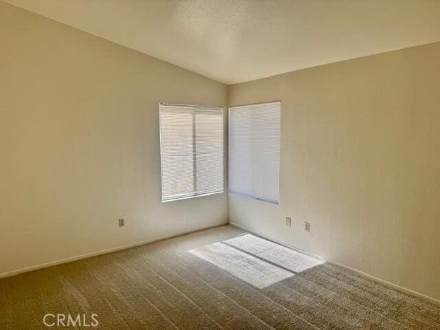 2125 Bramble Ln, Palmdale, CA 93550 - carpeted empty room with lofted ceiling and baseboards