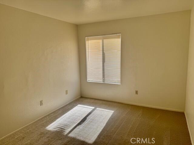 2125 Bramble Ln, Palmdale, CA 93550 - carpeted empty room with baseboards