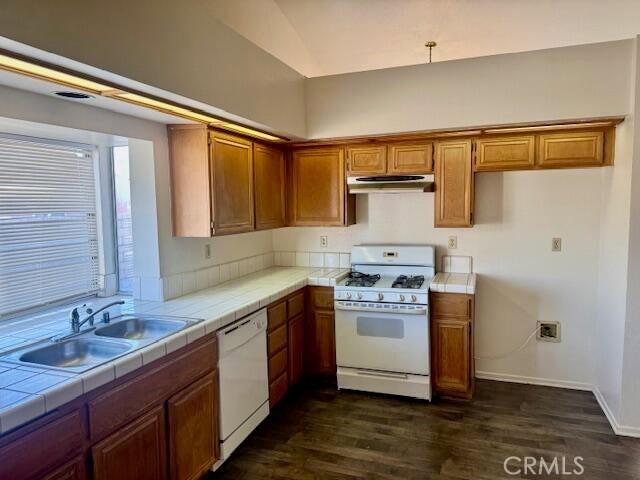 2125 Bramble Ln, Palmdale, CA 93550 - kitchen featuring white appliances, under cabinet range hood, tile counters, a sink, and brown cabinetry