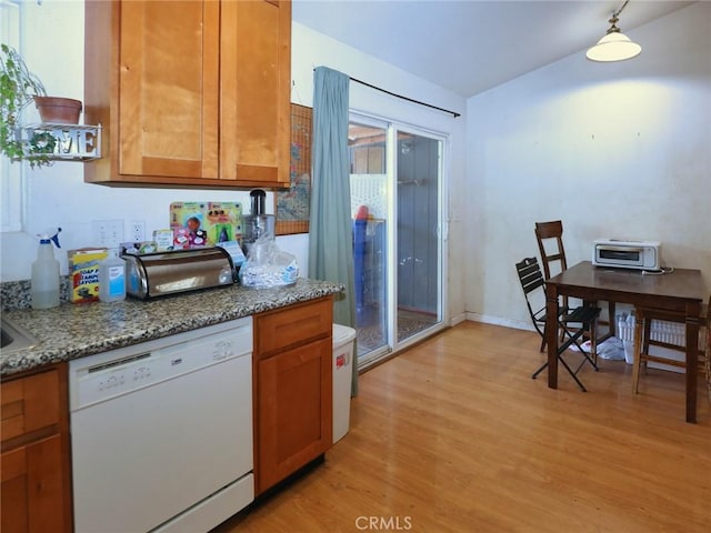 15595 34th Ave, Clearlake, CA 95422 - kitchen featuring white dishwasher, light wood-style floors, brown cabinetry, and light stone counters