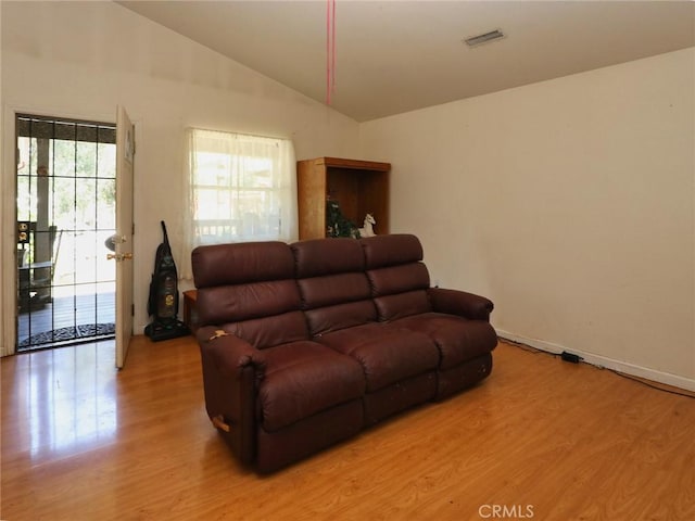 15595 34th Ave, Clearlake, CA 95422 - living area featuring vaulted ceiling, light wood-style floors, and baseboards