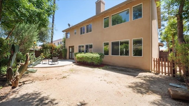25030 Crimson Lasso Dr, Wildomar, CA 92595 - rear view of house featuring a patio, a chimney, and stucco siding