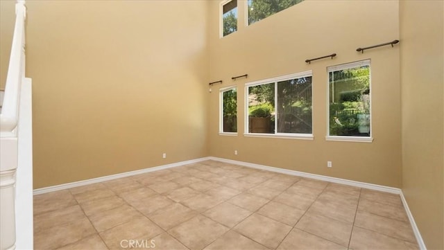 25030 Crimson Lasso Dr, Wildomar, CA 92595 - empty room with light tile patterned flooring, baseboards, and a towering ceiling