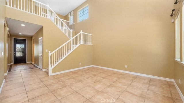 25030 Crimson Lasso Dr, Wildomar, CA 92595 - foyer featuring stairs, light tile patterned flooring, baseboards, and a towering ceiling