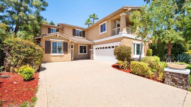 25030 Crimson Lasso Dr, Wildomar, CA 92595 - view of front of property with stucco siding, driveway, an attached garage, and a balcony