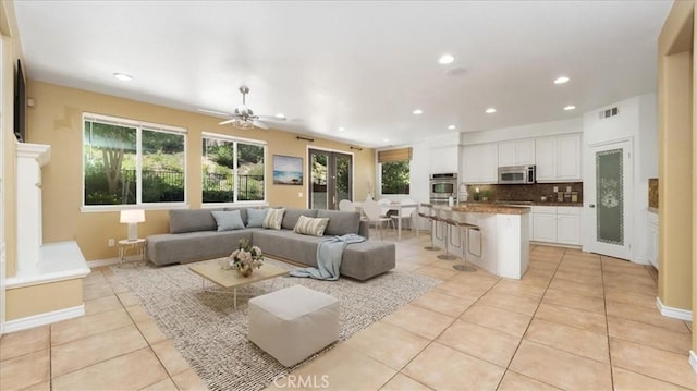 25030 Crimson Lasso Dr, Wildomar, CA 92595 - living room with light tile patterned flooring, plenty of natural light, recessed lighting, a ceiling fan, and baseboards