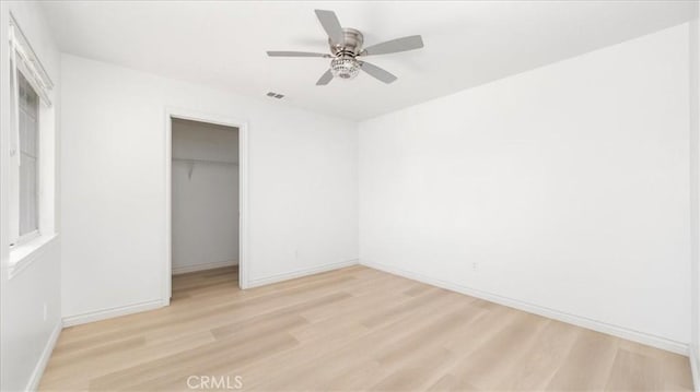 25030 Crimson Lasso Dr, Wildomar, CA 92595 - unfurnished bedroom with light wood-style flooring, a closet, baseboards, and ceiling fan