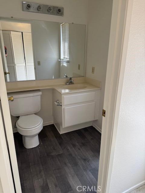 37733 Harvey St, Palmdale, CA 93550 - bathroom featuring wood finished floors, toilet, vanity, and baseboards