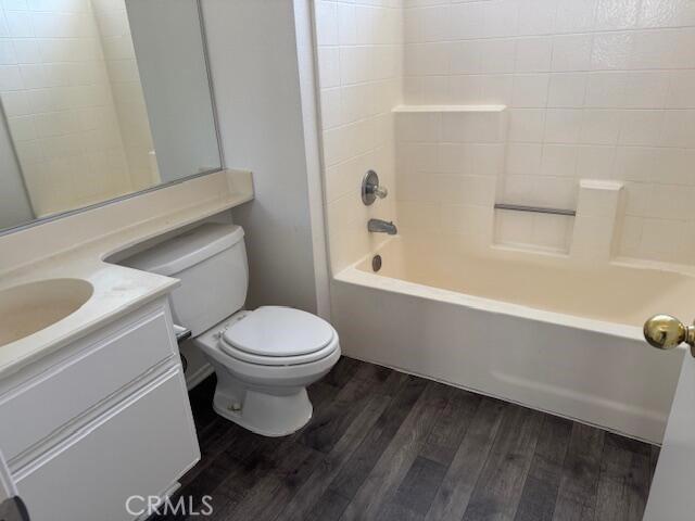 37733 Harvey St, Palmdale, CA 93550 - full bathroom with wood finished floors, vanity, toilet, and tub / shower combination
