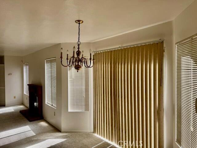 37733 Harvey St, Palmdale, CA 93550 - unfurnished dining area with a chandelier and carpet floors