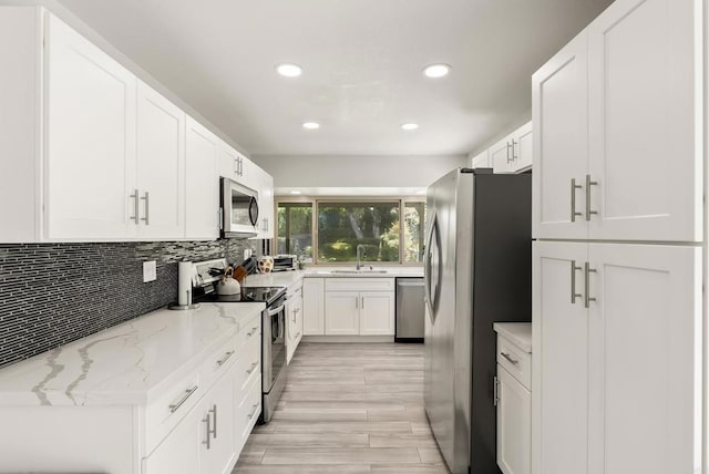 708 Santa Florencia, Solana Beach, CA 92075 - kitchen featuring appliances with stainless steel finishes, a sink, recessed lighting, white cabinets, and backsplash