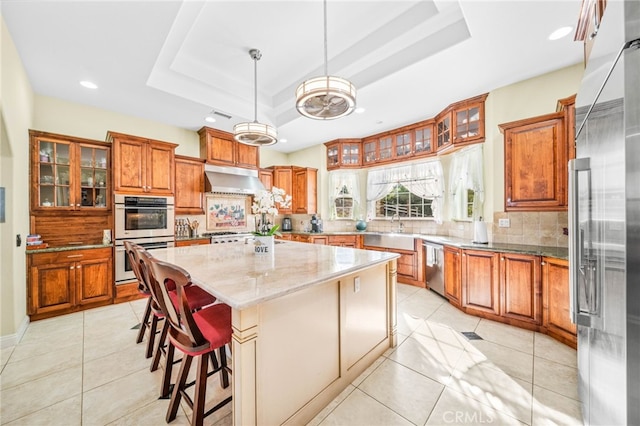 37626 Via Majorca, Murrieta, CA 92562 - kitchen with stainless steel appliances, brown cabinets, a raised ceiling, a sink, and recessed lighting