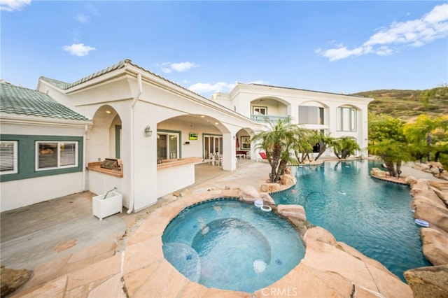 37626 Via Majorca, Murrieta, CA 92562 - rear view of house with a patio area, a pool with connected hot tub, and stucco siding