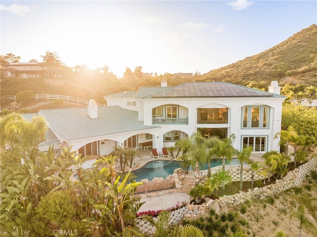 37626 Via Majorca, Murrieta, CA 92562 - rear view of house featuring a balcony, a chimney, a patio area, an outdoor pool, and a mountain view