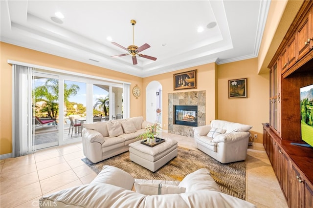 37626 Via Majorca, Murrieta, CA 92562 - living room with a raised ceiling, a high end fireplace, a ceiling fan, light tile patterned floors, and arched walkways