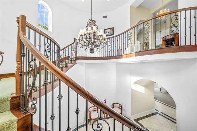 37626 Via Majorca, Murrieta, CA 92562 - staircase featuring a chandelier, a high ceiling, arched walkways, and baseboards