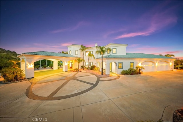 37626 Via Majorca, Murrieta, CA 92562 - mediterranean / spanish house featuring curved driveway, stucco siding, a tiled roof, and a garage