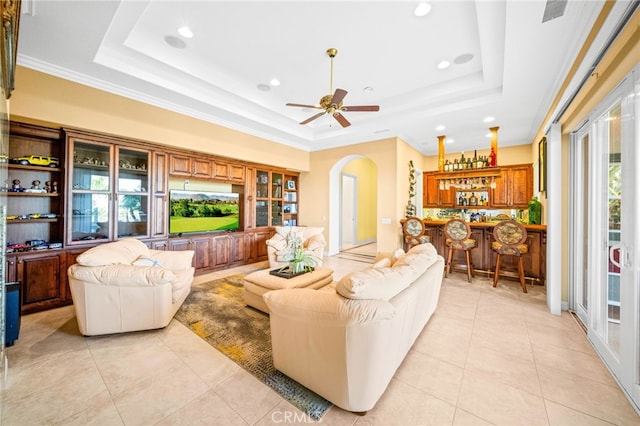 37626 Via Majorca, Murrieta, CA 92562 - living area featuring a tray ceiling, a bar, arched walkways, light tile patterned floors, and recessed lighting