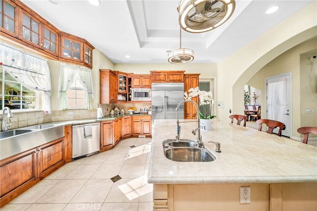 37626 Via Majorca, Murrieta, CA 92562 - kitchen featuring a sink, built in appliances, a large island, arched walkways, and decorative backsplash