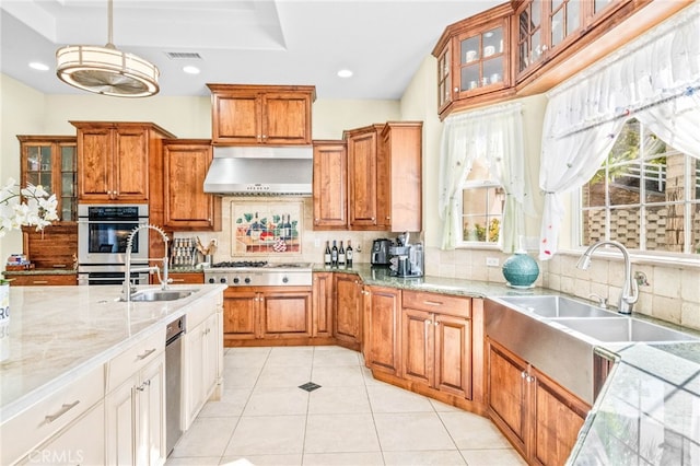 37626 Via Majorca, Murrieta, CA 92562 - kitchen featuring a sink, decorative backsplash, brown cabinetry, wall chimney exhaust hood, and recessed lighting
