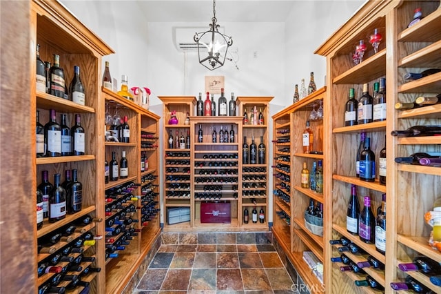 37626 Via Majorca, Murrieta, CA 92562 - wine area featuring dark stone finish floors, a wall mounted AC, and a chandelier