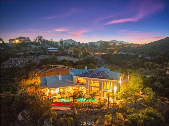 37626 Via Majorca, Murrieta, CA 92562 - back of property at dusk featuring a mountain view