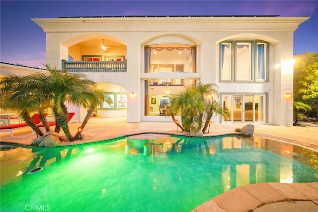 37626 Via Majorca, Murrieta, CA 92562 - back of property featuring a patio area, a balcony, stucco siding, an outdoor pool, and french doors