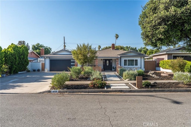 1459 Clock Ave, Redlands, CA 92374 - view of front facade featuring concrete driveway, a garage, and a chimney
