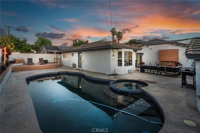 1459 Clock Ave, Redlands, CA 92374 - view of swimming pool featuring a wooden deck, a fenced backyard, a pool with connected hot tub, an outdoor hangout area, and a patio