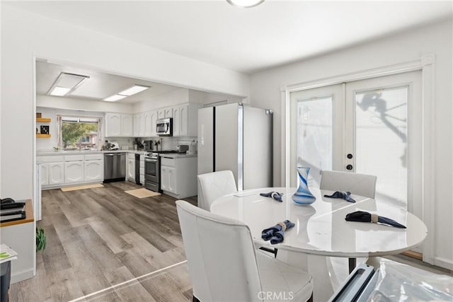 1459 Clock Ave, Redlands, CA 92374 - dining room with light wood-type flooring and french doors