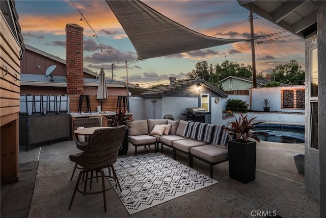 1459 Clock Ave, Redlands, CA 92374 - patio terrace at dusk featuring a patio, area for grilling, and a fenced backyard