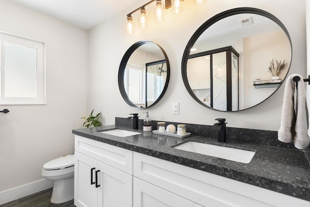 6153 Baltimore Dr, La Mesa, CA 91942 - full bathroom featuring double vanity, toilet, baseboards, and wood finished floors